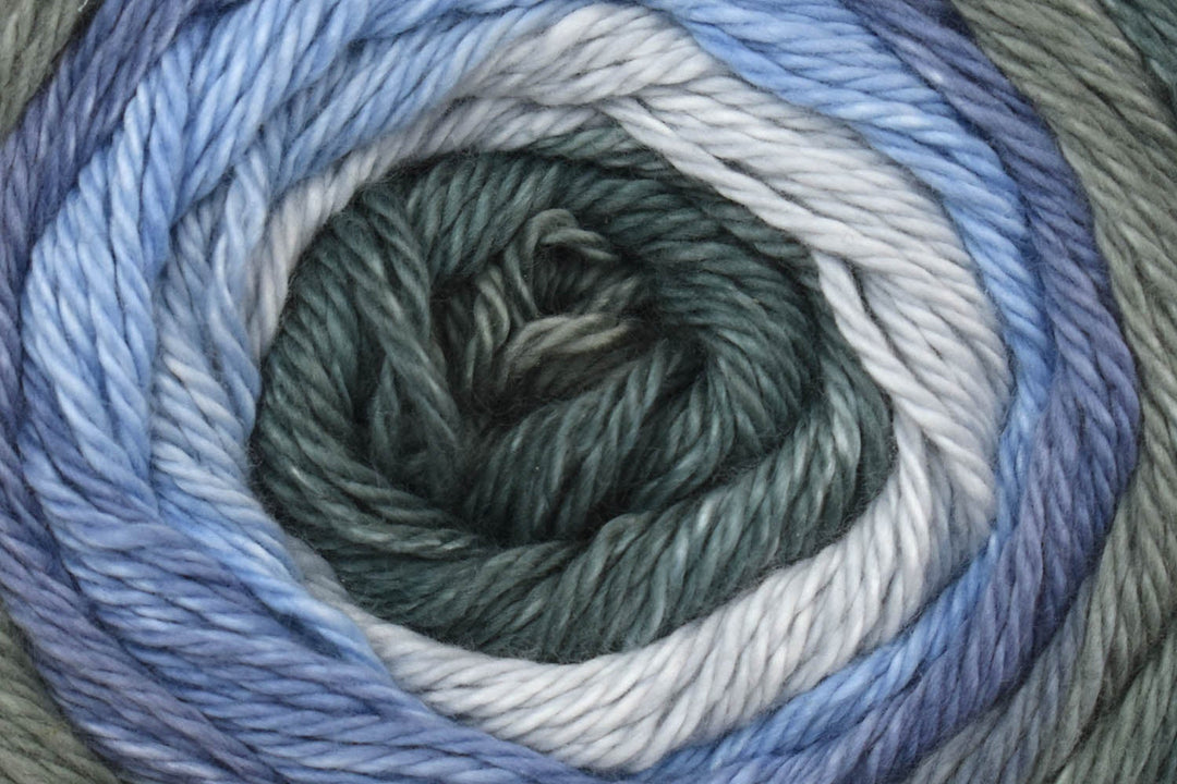 Close-up of a skein of yarn with green, white, and blue colors.