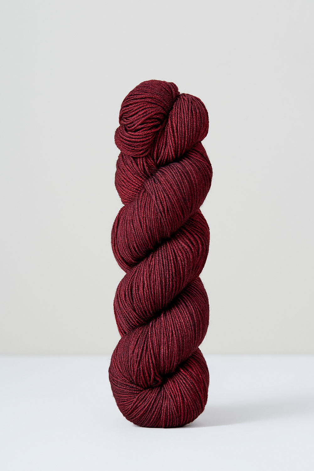 Red skein of yarn on a white background