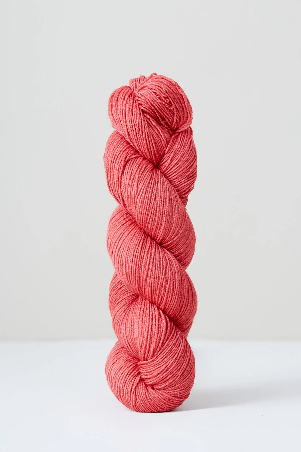 Pink skein of yarn on a white background