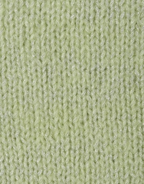 A close-up of a light sage green knit fabric with a subtle metallic sheen