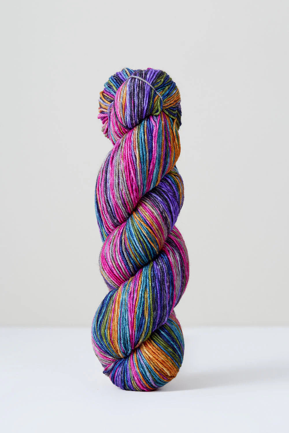 Pink and purple skein of yarn on a white background