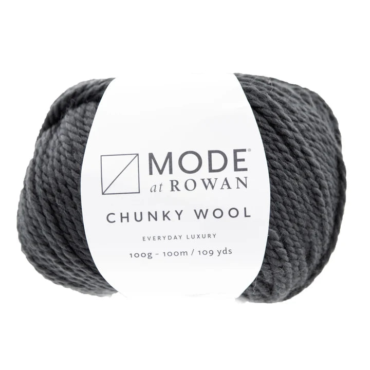 A single ball of Mode at Rowan Chunky Wool yarn in a dark charcoal gray color, wrapped with a white paper label, on a solid white background.
