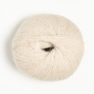 Ball of cream-colored yarn on a white background