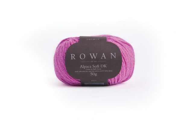 Pink skein of yarn with a Rowan label on a white background