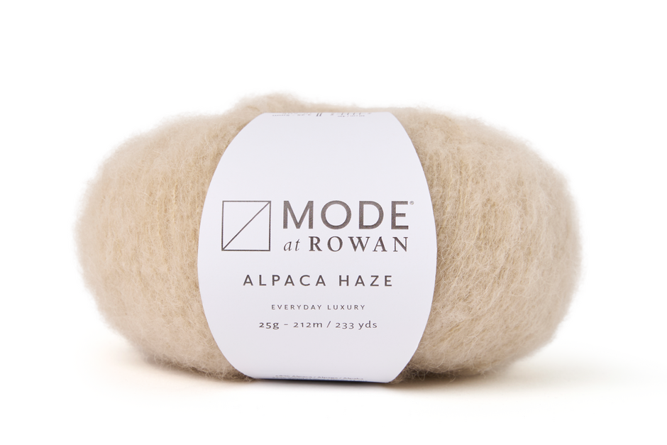beige Ball of Mode by Rowan Alpaca Haze yarn on a white background