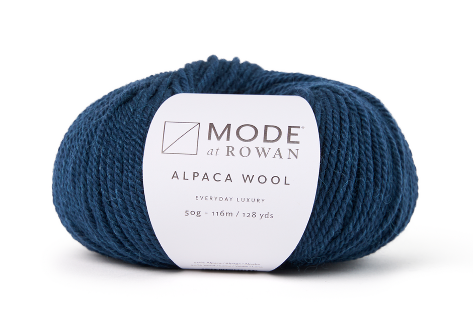 Blue skein of alpaca wool with Rowan label on a white background