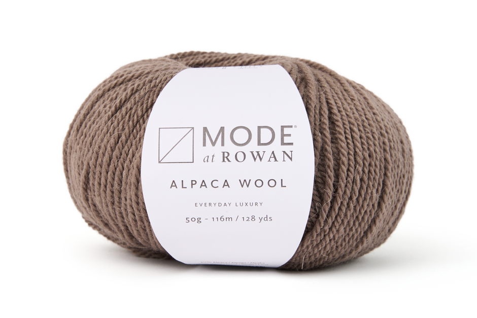 Brown skein of alpaca wool with Rowan label on a white background