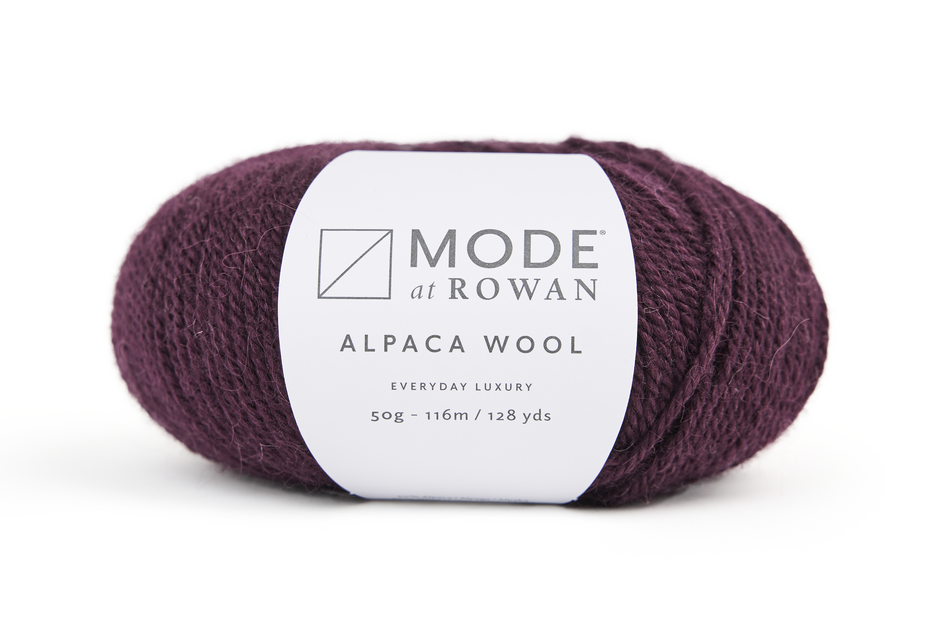 Ball of plum purple yarn with a 'Mode at Rowan' label on a white background
