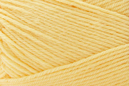 Close-up of a ball of light yellow yarn