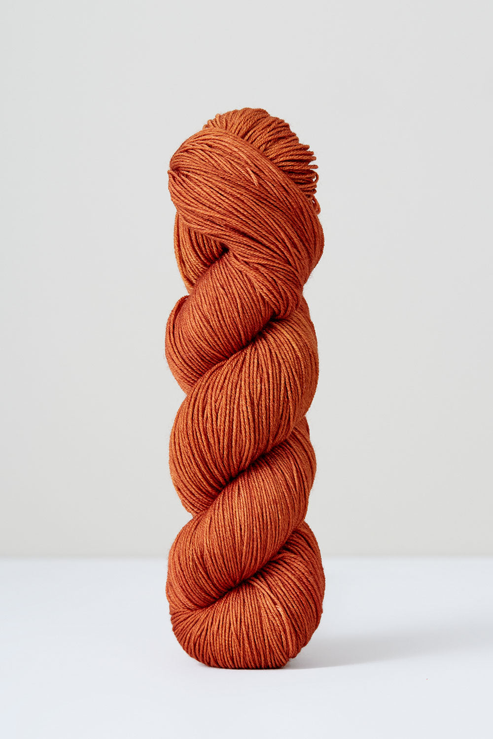 Orange skein of yarn on a white background