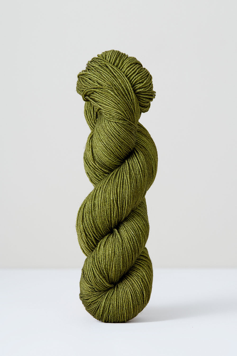 Green skein of yarn on a white background