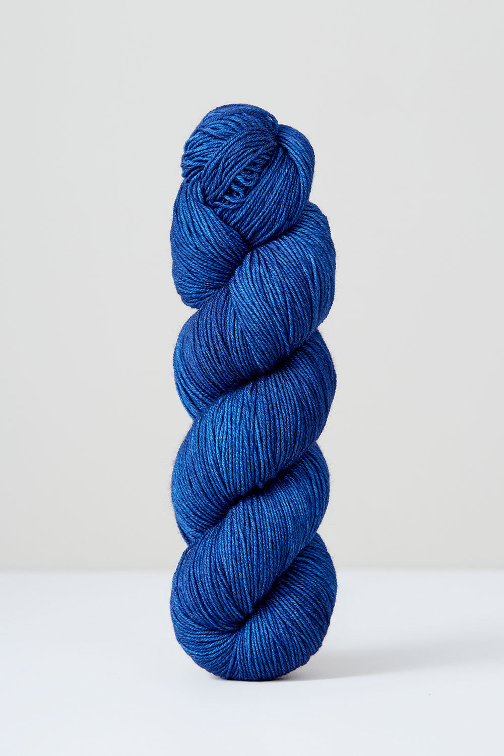 Blue skein of yarn on a white background