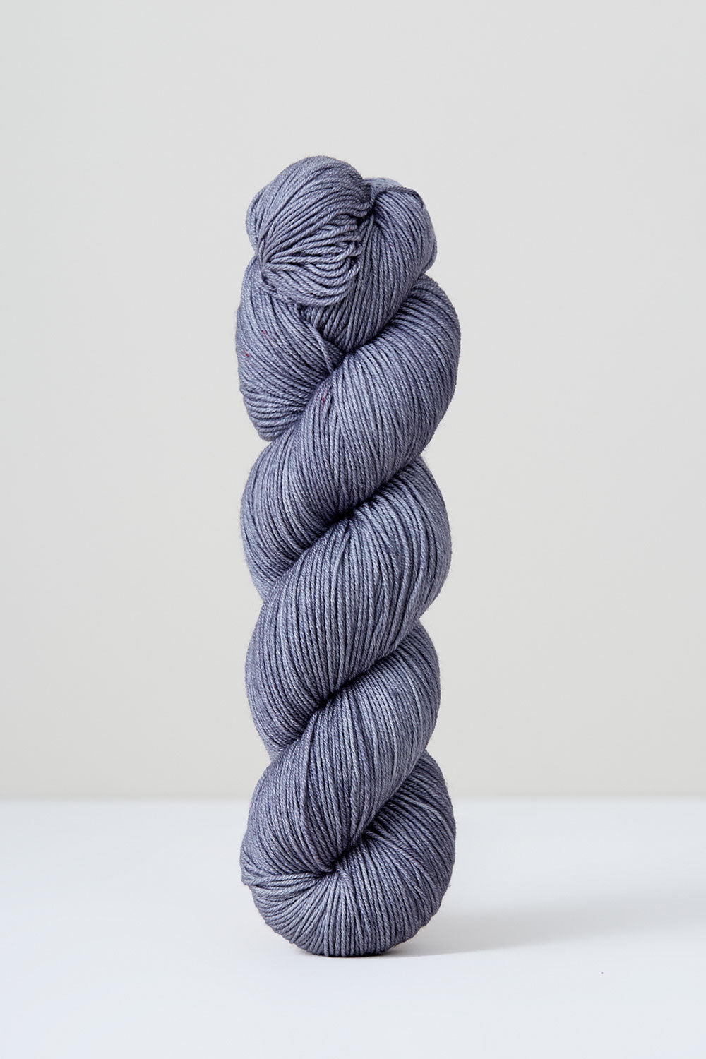 Grey skein of yarn on a white background