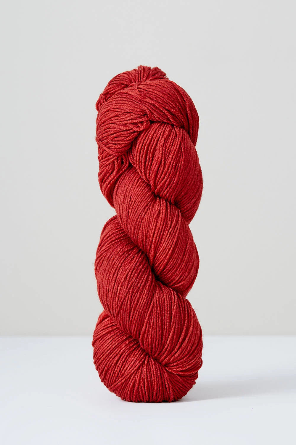 Red skein of yarn on a white background