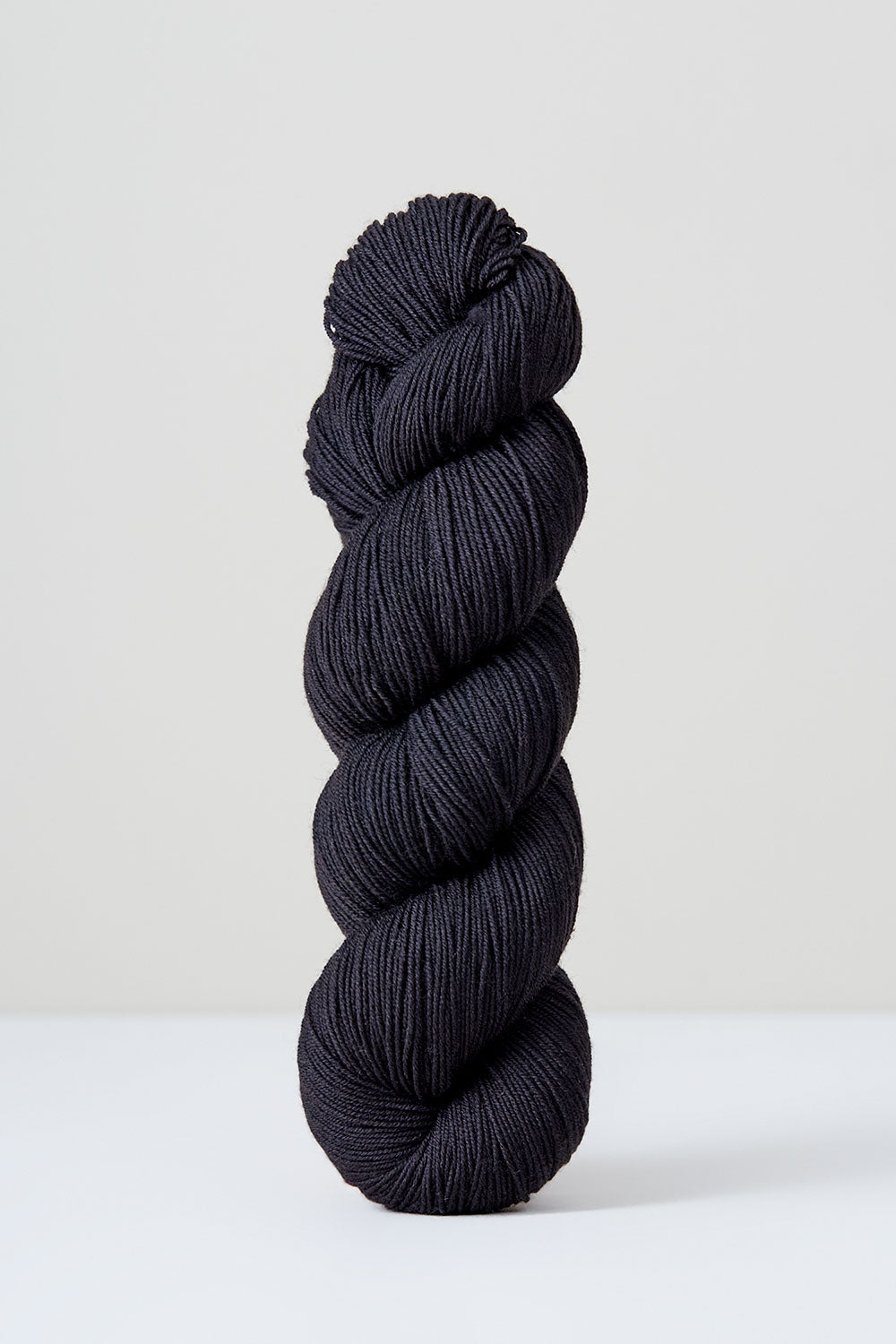 Black skein of yarn on a white background