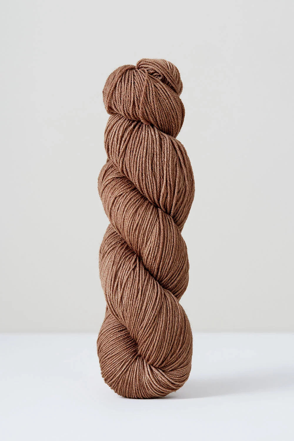 Brown skein of yarn on a white background