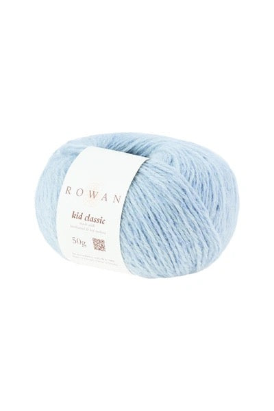 A ball of light blue yarn with a white paper label reading 'ROWAN kid classic' on a plain white background.