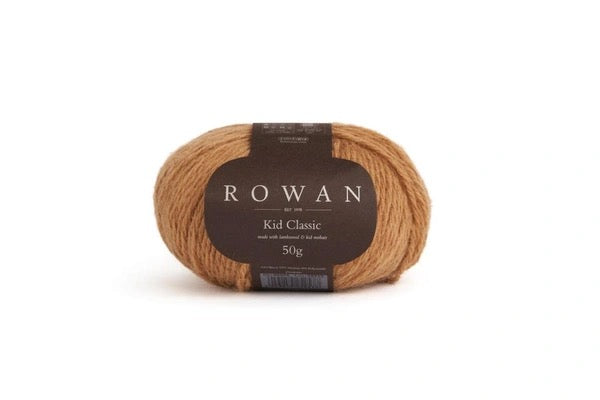 A single skein of Rowan Kid Classic yarn in a warm tan-brown color, with a dark brown paper label, on a clean white background.