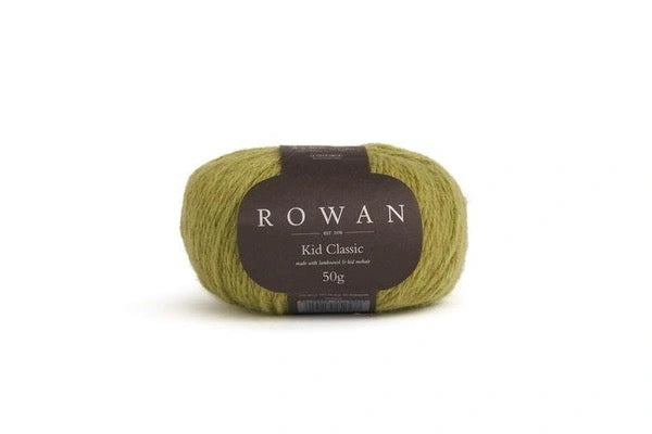 A single skein of Rowan of Knit Rowan Kid Classic yarn in a muted olive green color, featuring a dark brown paper label with white text, set against a plain white background.