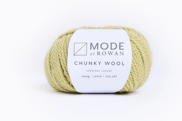 A skein of pale yellow-green chunky wool yarn with a white paper label reading 'MODE at ROWAN CHUNKY WOOL' on a clean white background.