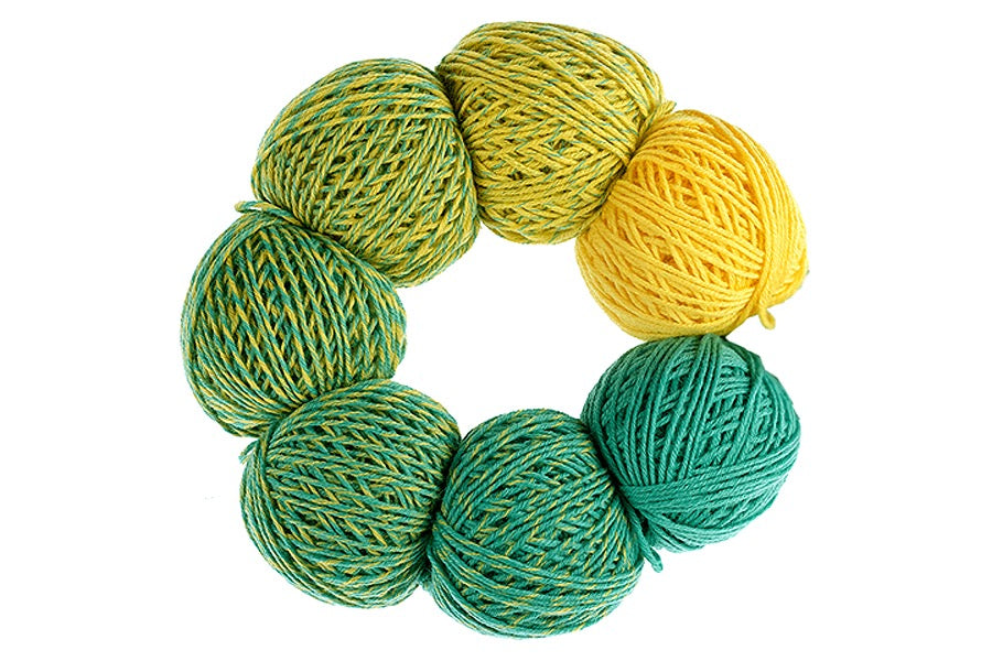 Mini skeins arranged in a circle to create a gradient from yellow to green