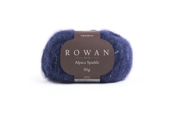 Navy color Ball of yarn with sequins with Rowan label on a white background