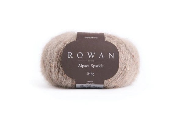 Taupe color Ball of yarn with sequins with Rowan label on a white background