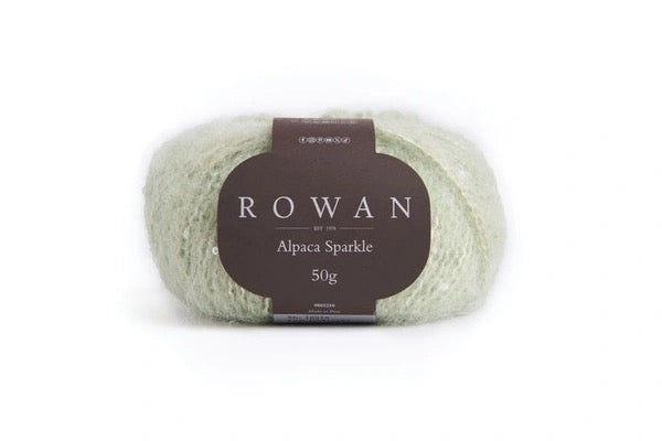 Light green color Ball of yarn with white sequins with Rowan label on a white background
