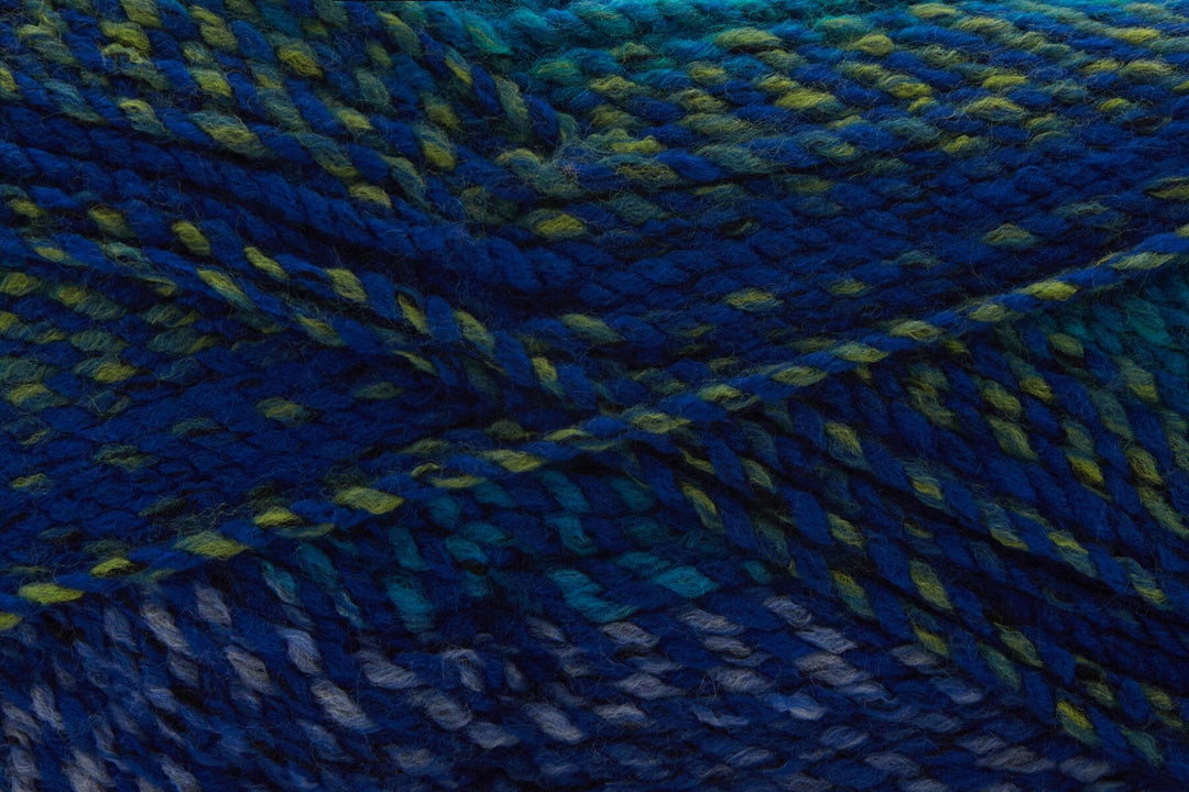 Close-up of variegated yarn of deep blue, teal, and yellow-green threads.