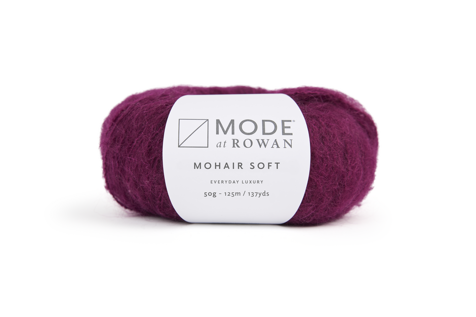 magenta skein of yarn with a Rowan label on a white background