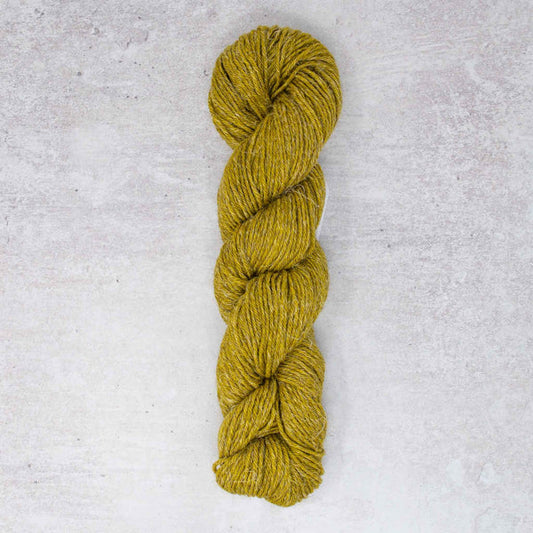 Photograph of a yellow green hank of yarn on a white textured background