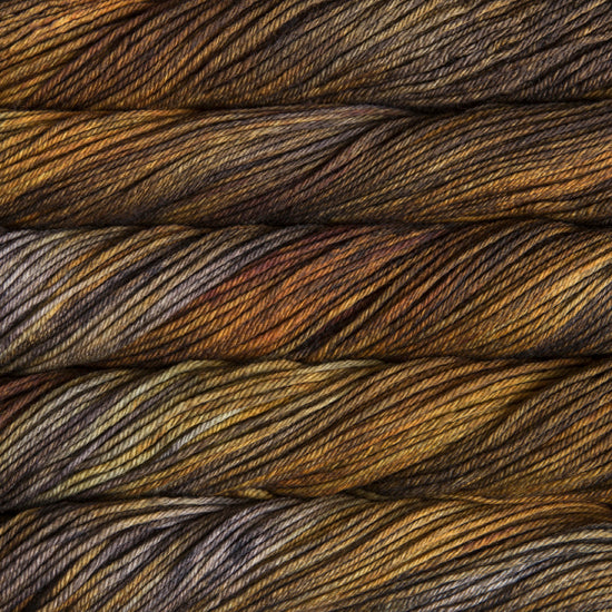 Close-up of multicolored yarn with brown, grey, and orange hues.