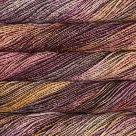 Close-up of multicolored yarn with shades of purple, brown, and yellow.