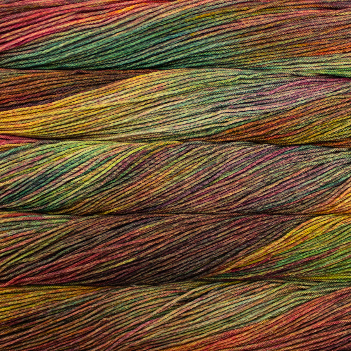 Close-up of multicolored yarn with shades of red, green, and yellow.