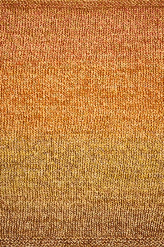 Close up of a swatch showing the brown, yellow, and orange gradient.