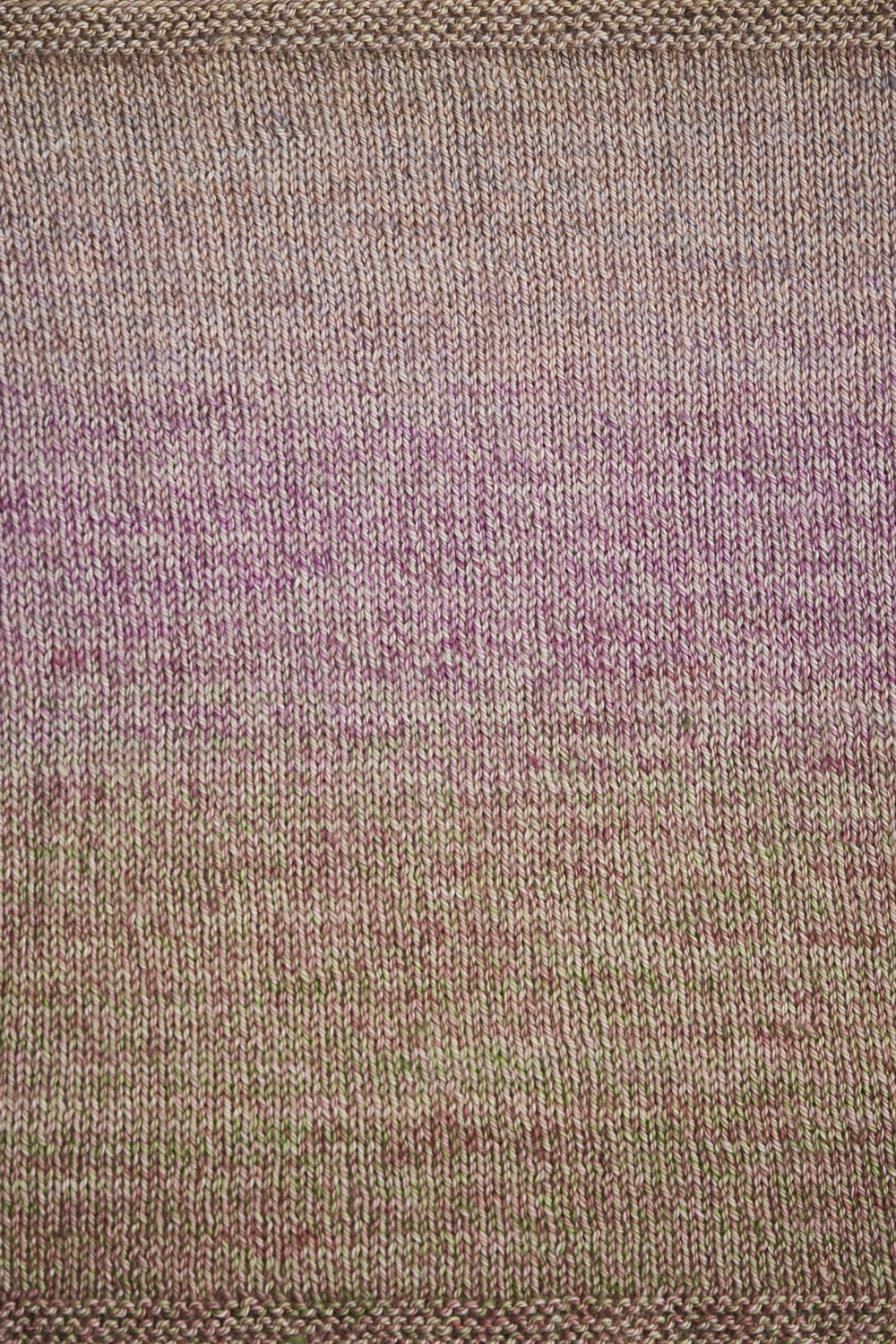 Close up of a swatch showing the green, pink, and yellow gradient.
