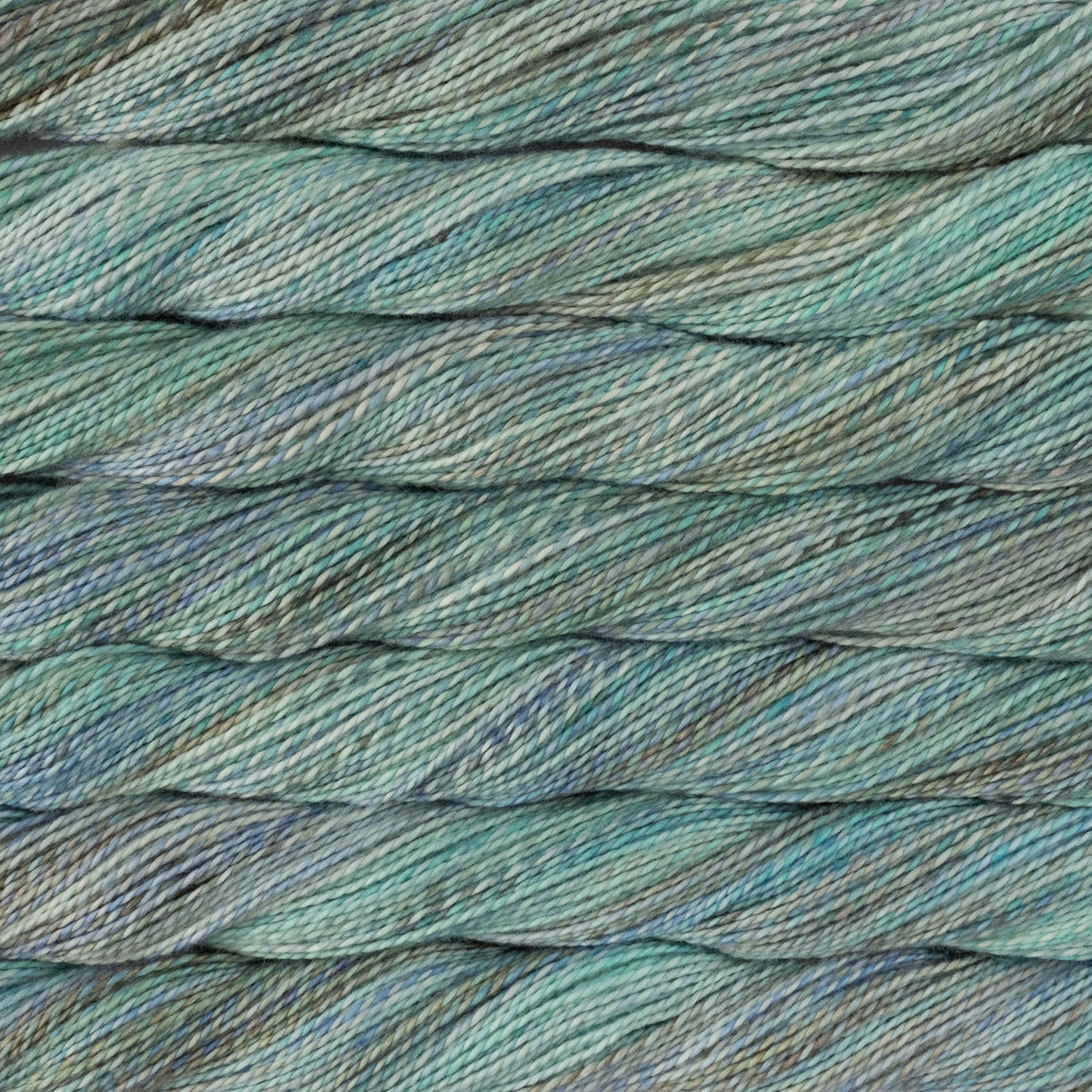 Close-up of twisted yarn strands in a variegated blend of muted teal, sage green, and soft blue-gray.