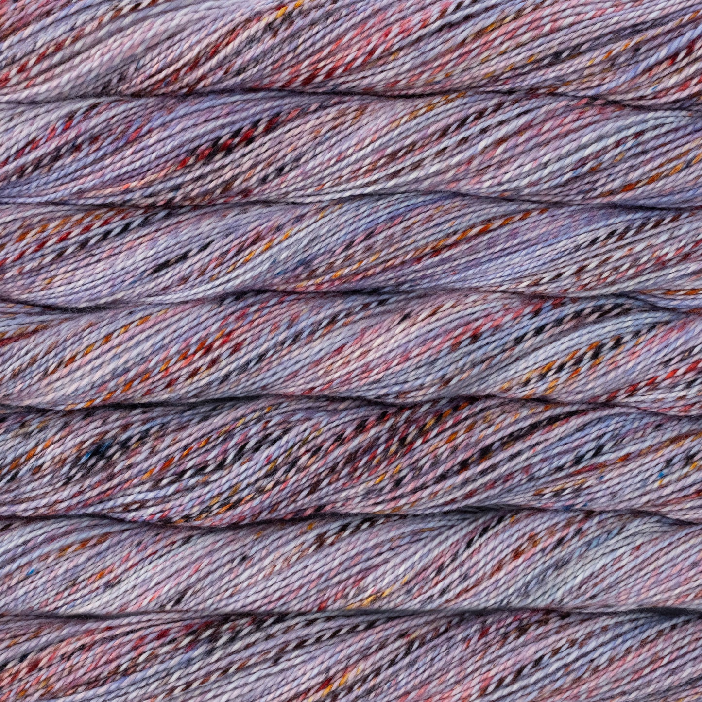 Close-up of multicolored yarn strands purples, reds and lavender