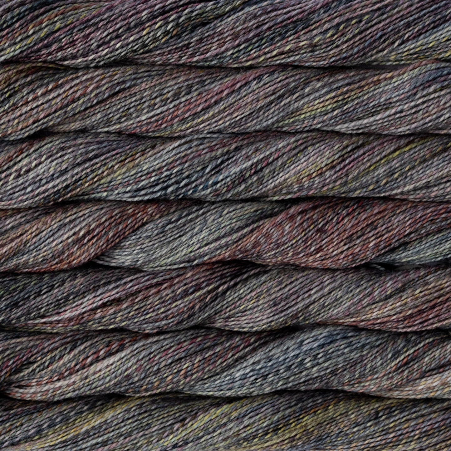 Close-up of multicolored yarn with shades of brown, gray, and black.