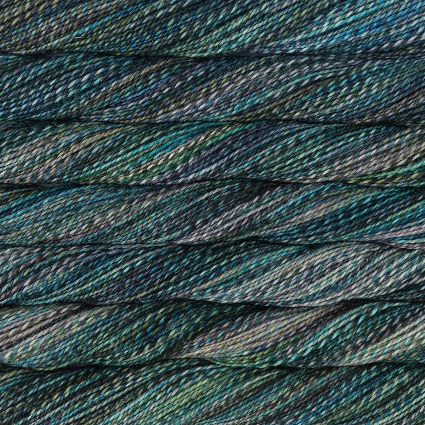 Close-up of variegated yarn with a twisted  texture in dark teal, blue, green, and gray tones.