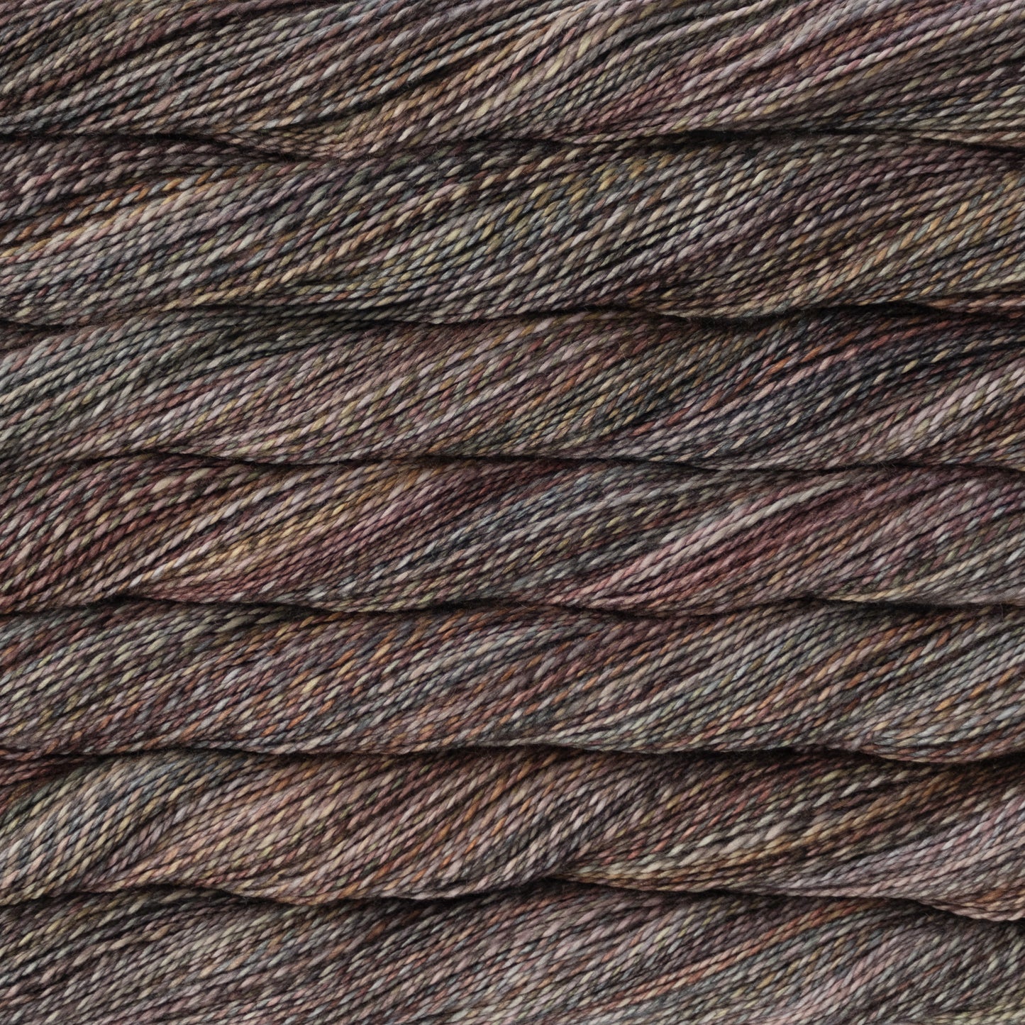 Close-up of twisted yarn strands in a variegated colorway of various browns and reds