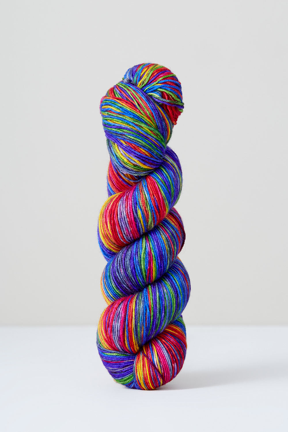 Multicolored skein of yarn on a white background