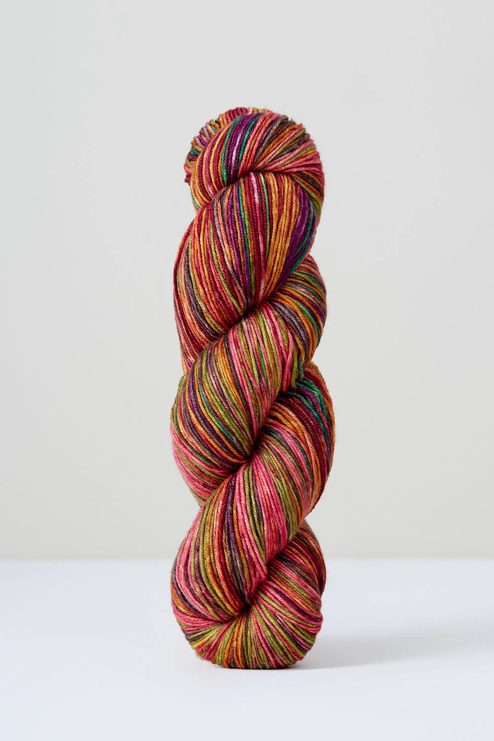 Orange skein of yarn on a white background