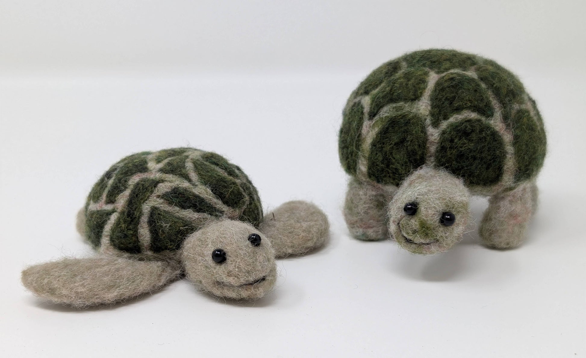 Two needle-felted turtles on a white background