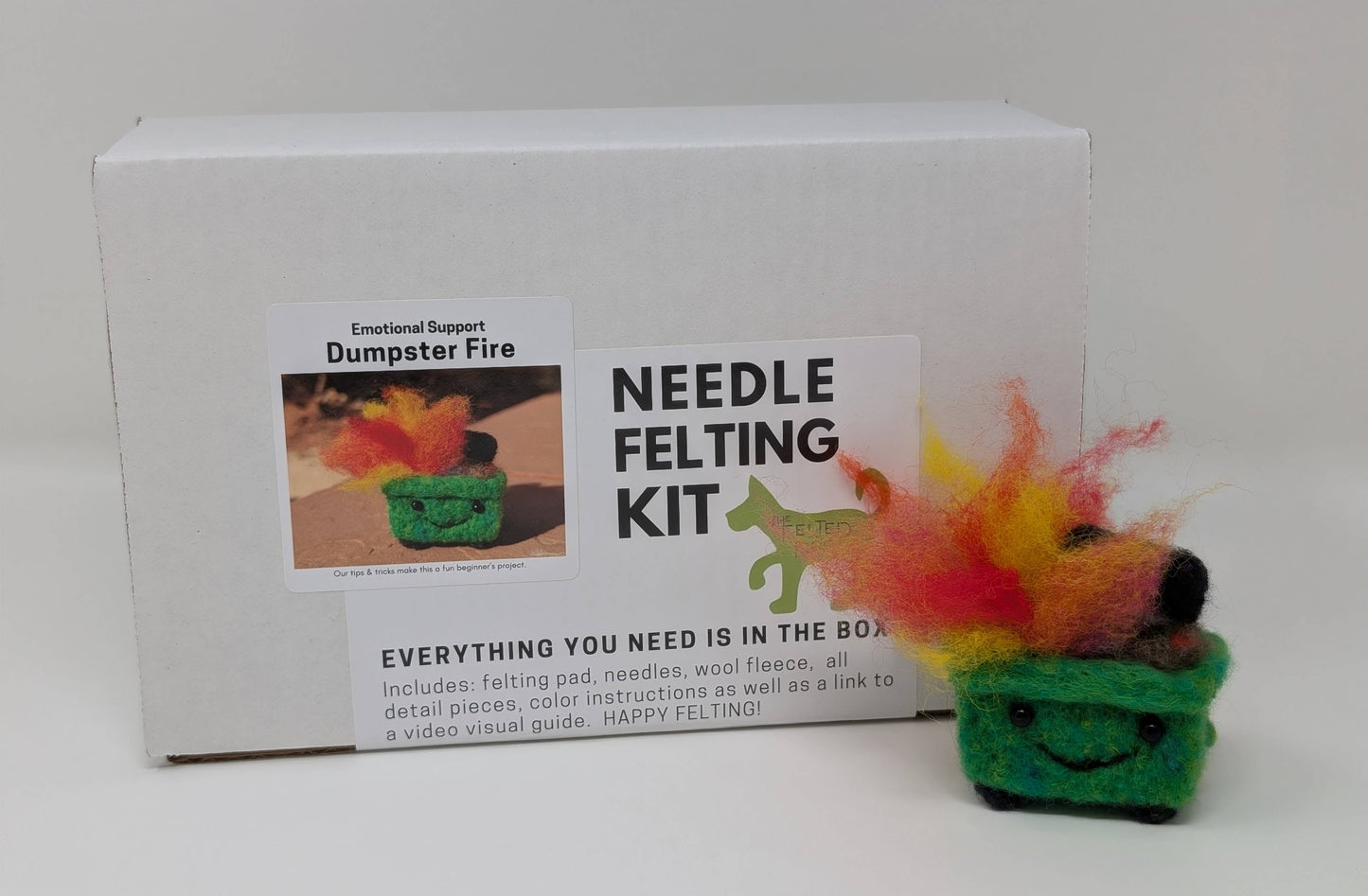 Needle felting kit with a small felted dumpster fire on a white background