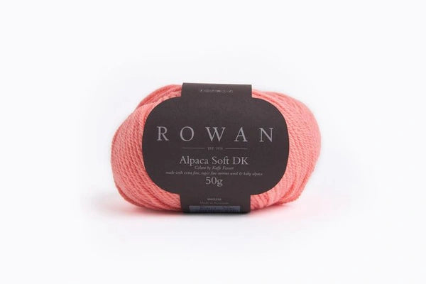 Coral skein of yarn with a Rowan label on a white background