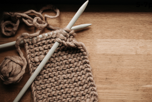 Promotional photo for Stringfield Yarn Collective with knitting materials 