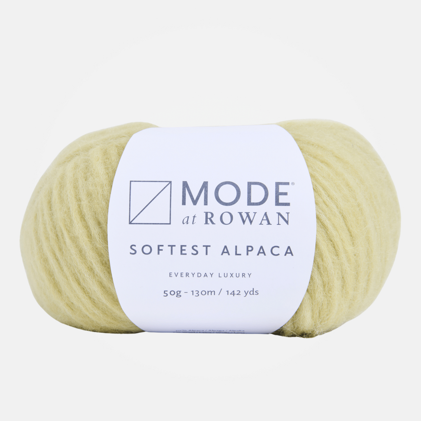 A ball of pale yellow alpaca yarn with a white paper label reading 'MODE at Rowan' and 'SOFTEST ALPACA'.