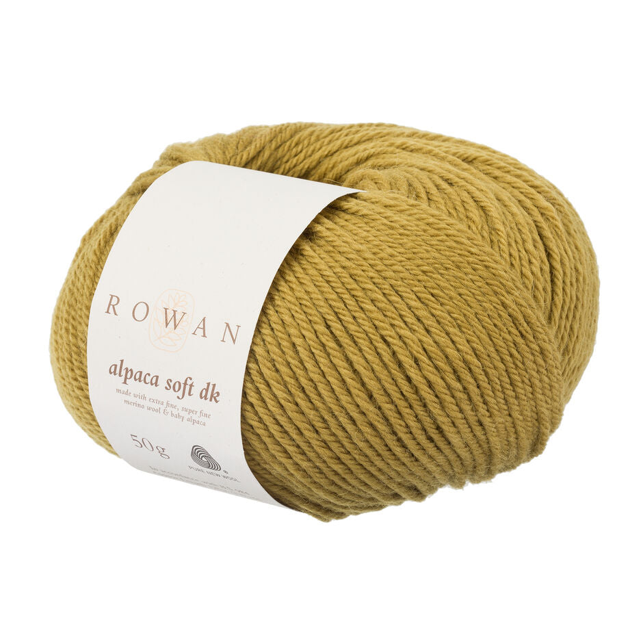 Mustard yellow skein of yarn with a Rowan label on a white background