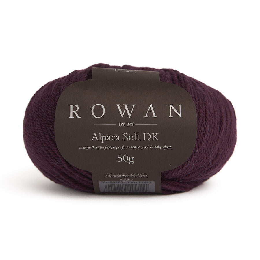 Dark purple skein of yarn with a Rowan label on a white background